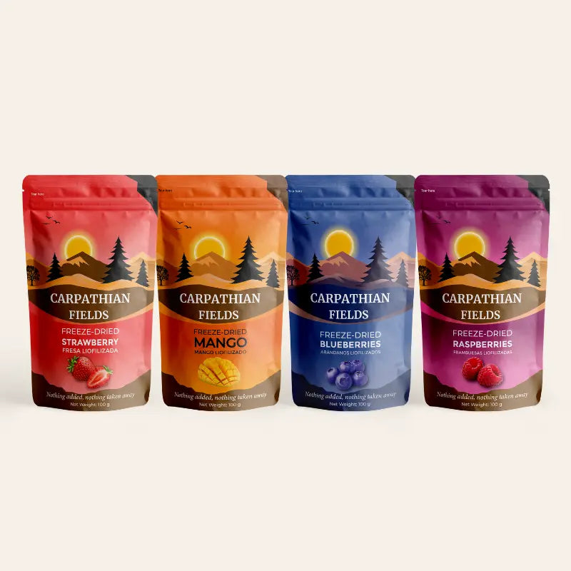 Four stand-up pouches of Carpathian Fields freeze dried fruit snacks in strawberry, mango, blueberries, and raspberries, arranged side by side.