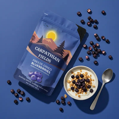 Freeze-dried blueberry pouch next to a breakfast yogurt bowl with spoon