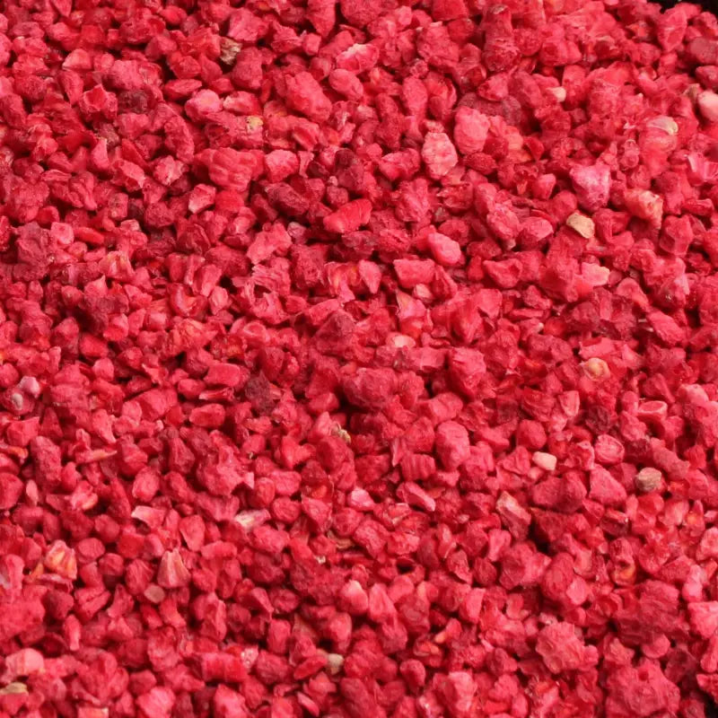 Close-up macro texture of pure freeze-dried raspberry crumbs