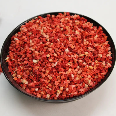 Freeze-dried strawberry pieces served in a black ceramic bowl