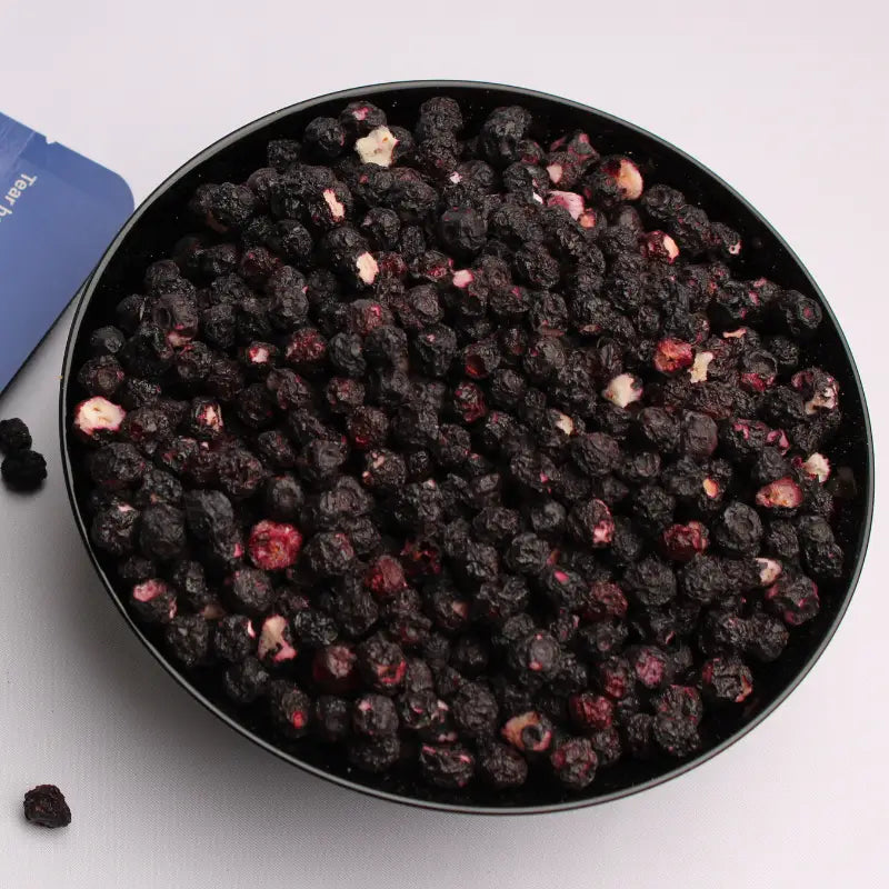 Freeze-dried whole blueberries served in a black ceramic bowl