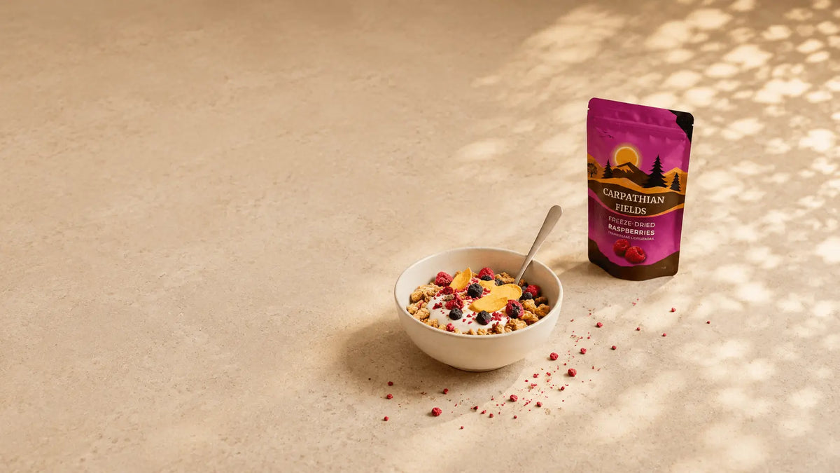 Carpathian Fields freeze-dried raspberries pouch next to a yogurt granola bowl on a beige background